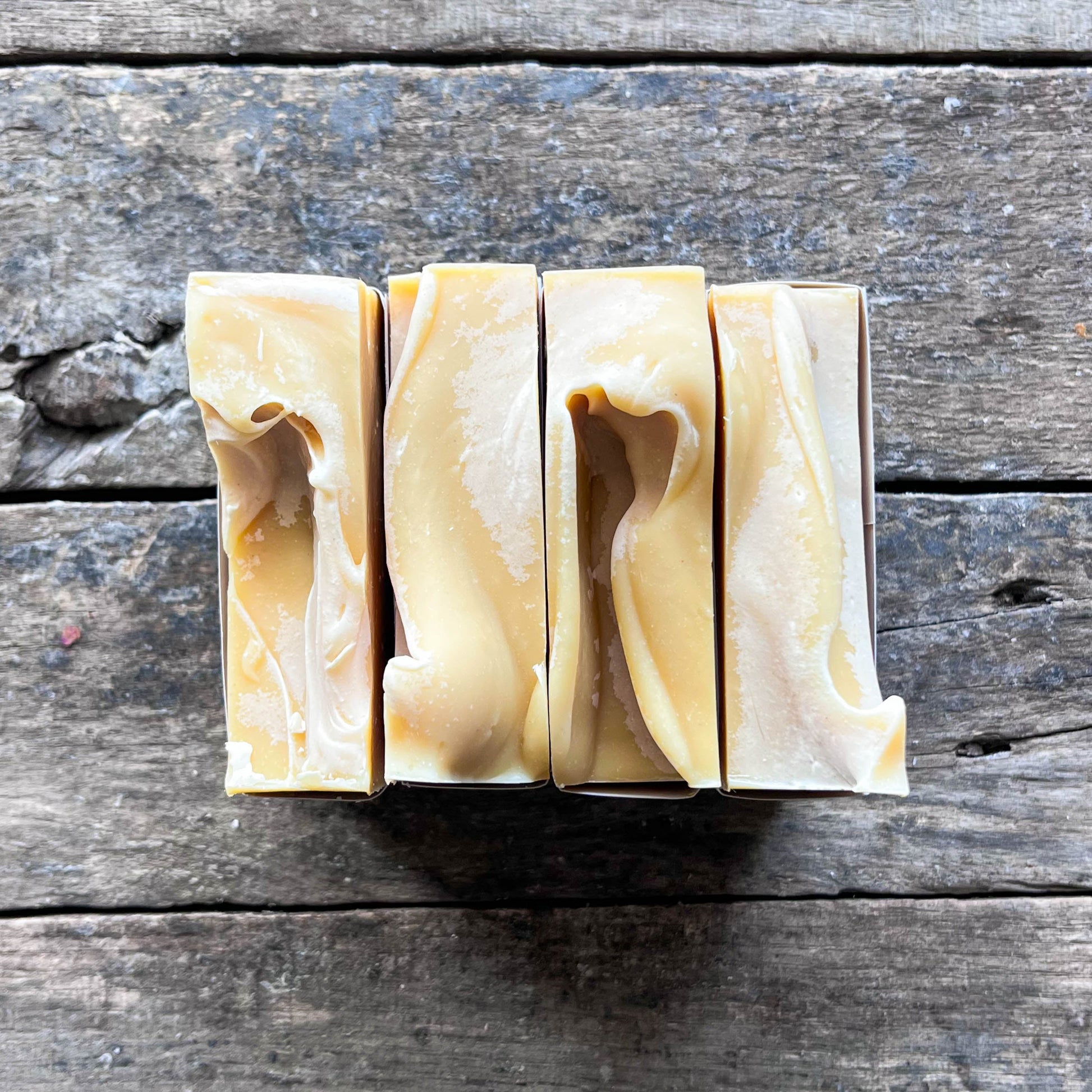 Bar of soap with a swirled design on a wooden surface