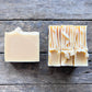 Two bars of soap on a wooden surface