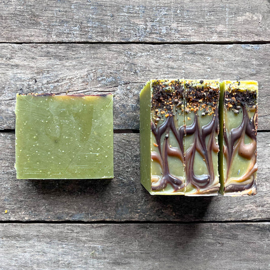 soap bars on a wooden surface, one top view and one laying on it's side