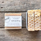 Bar of soap with a honeycomb pattern and oat topping