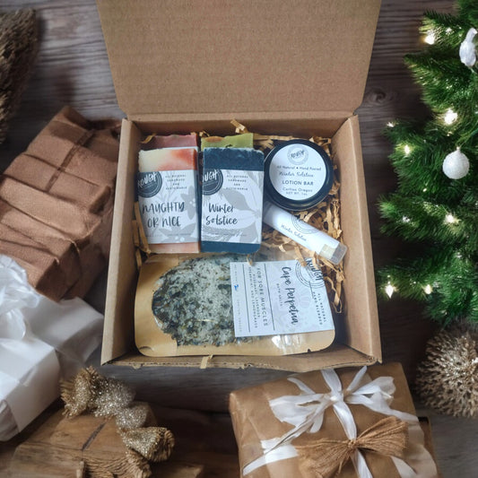 Holiday gift set with 4 Holiday soaps, Lotion Bar in tin case, Lip Balm, and Bath salts bag.